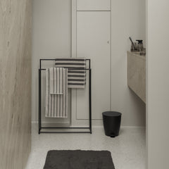 Bathroom interior with towel rack, toilet, and sink.