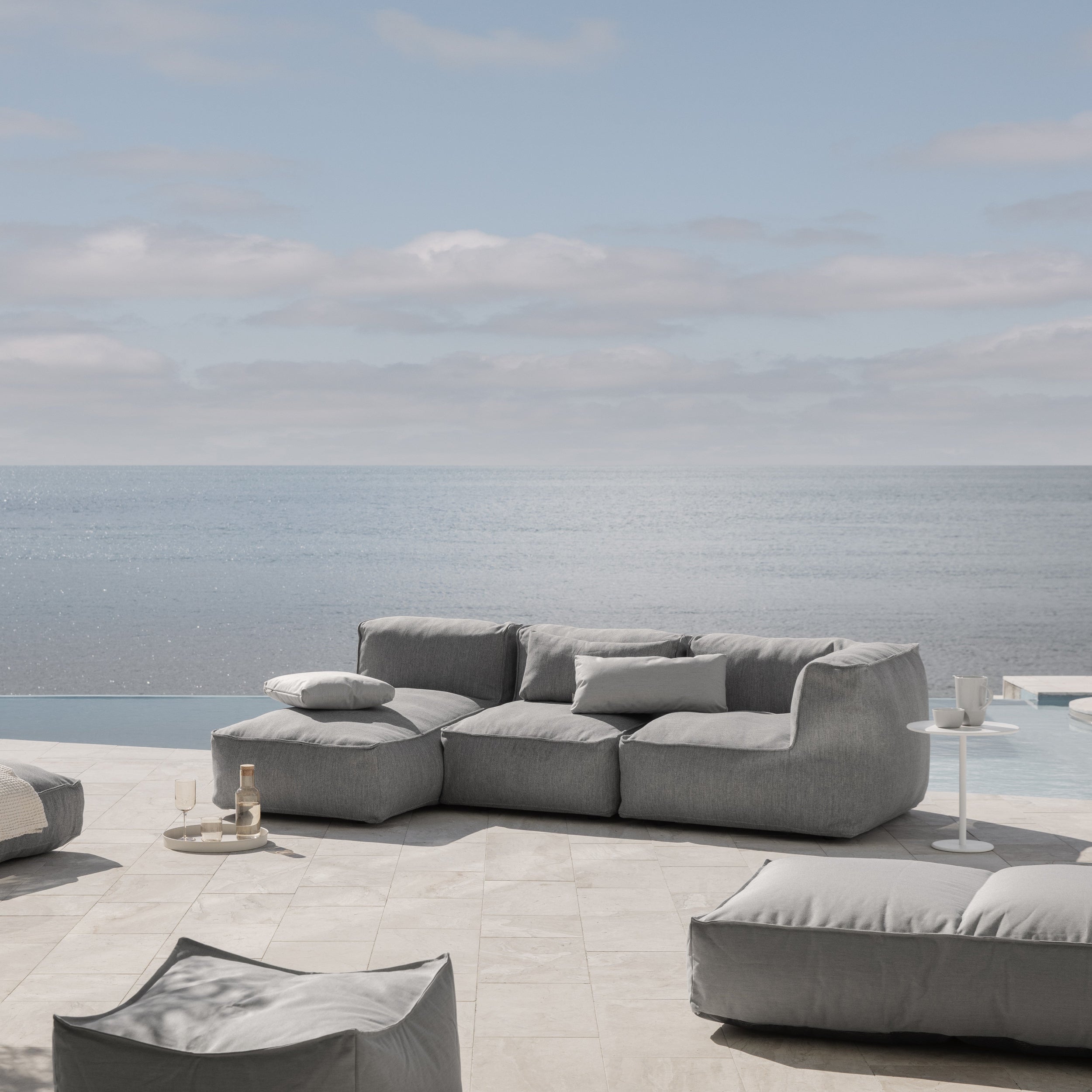 Gray outdoor sofa set on a patio with ocean view