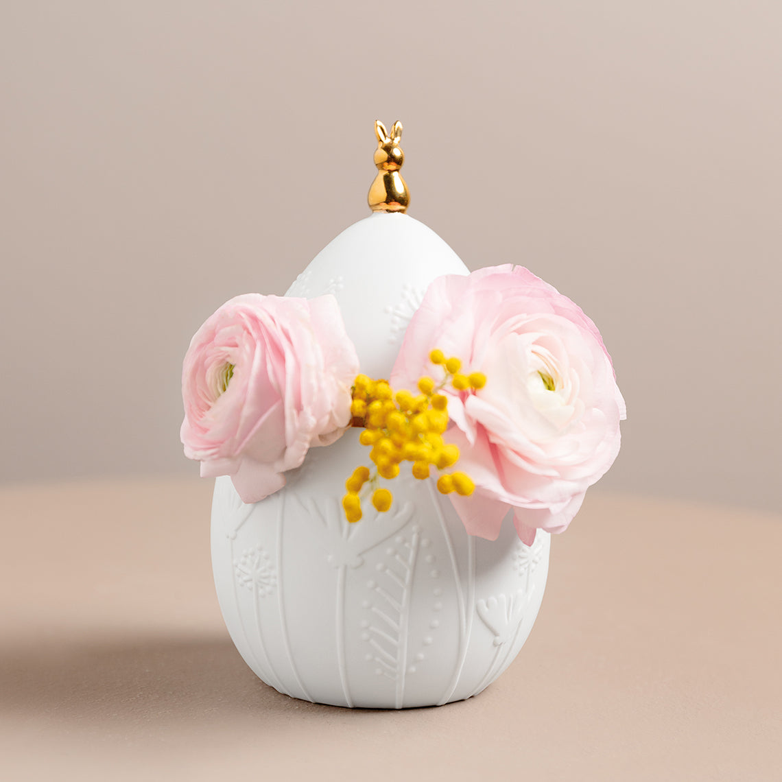 Easter Egg Jar with pink flowers and a gold accent on a beige background