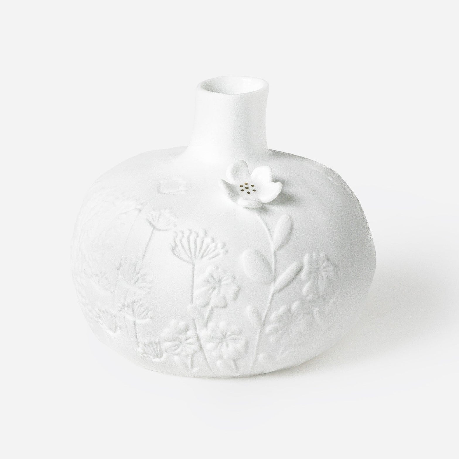 Porcelain Stories White porcelain vase with floral patterns on a white background.